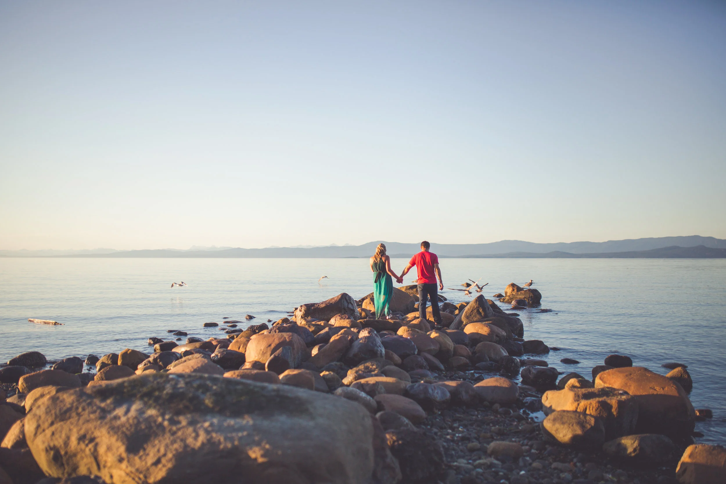 couple walking beach at sunset in Qualicum Beach