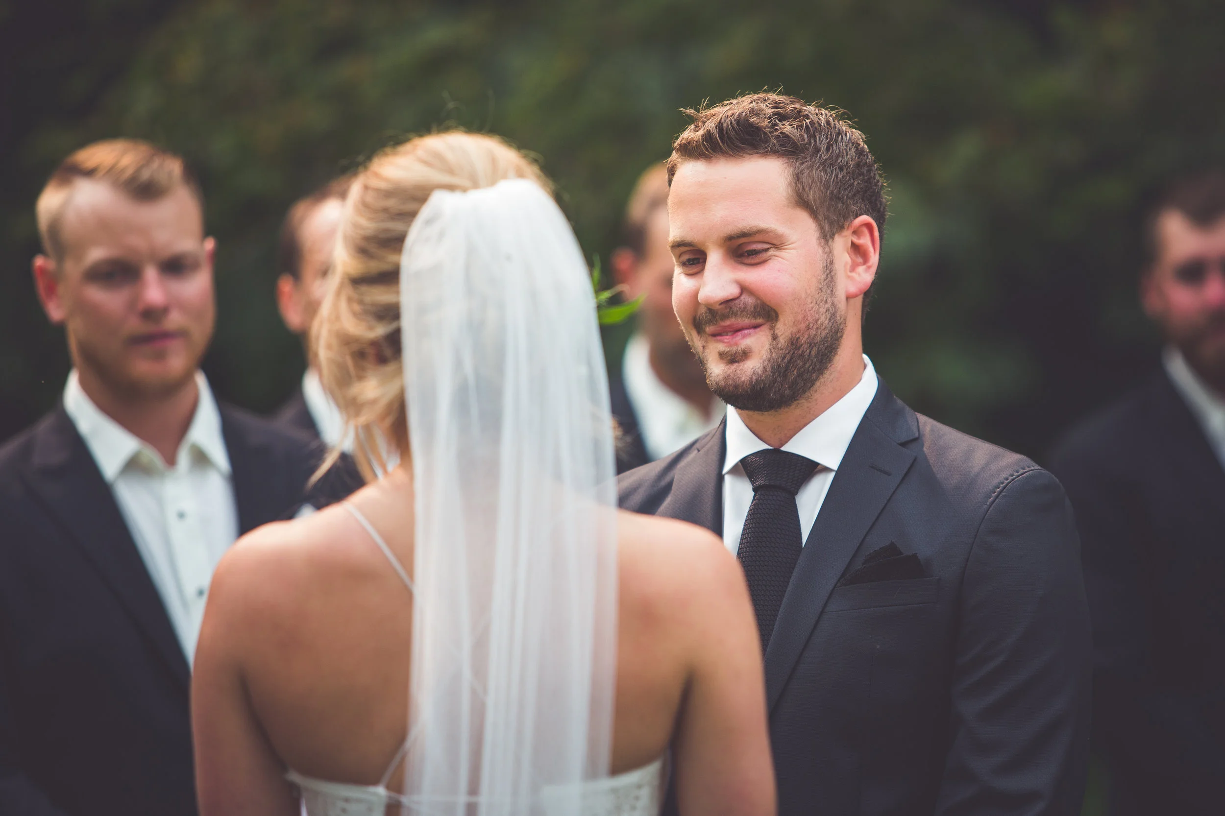 groom smiles at bride during Qualicum Beach wedding