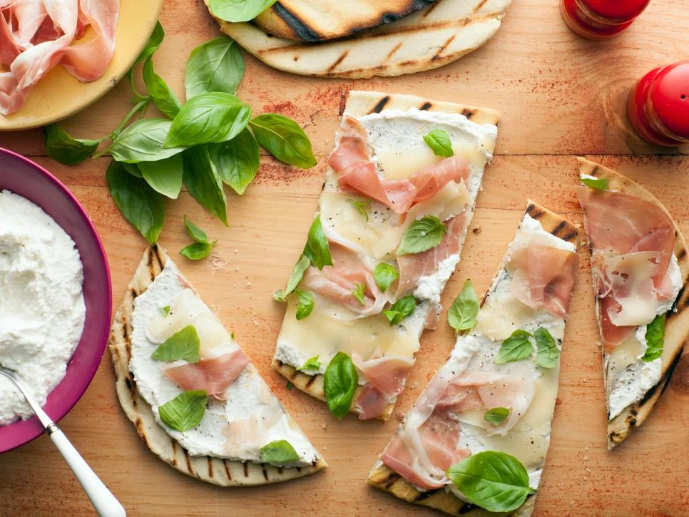 Giada says, "Piadini is a lot like a pizza, except that the crust doesn't rise and it's typically cooked on a grill to give it a nice, smoky flavor and crunchy crust. You can top a piadina with anything you like. This sauceless combination is very typical of northern Italy, where piadini are especially popular."