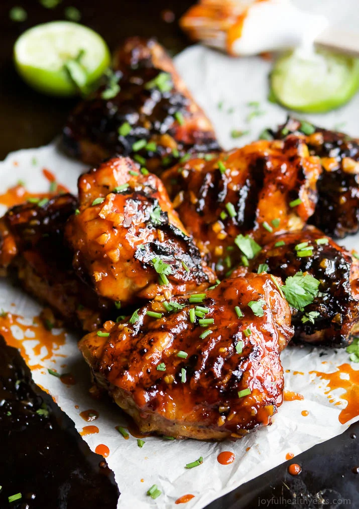 Sweet & Spicy HONEY SRIRACHA GRILLED CHICKEN THIGHS – juicy smoky chicken thighs slathered in an easy Honey Sriracha glaze that will make you swoon! I guarantee these will be a hit!