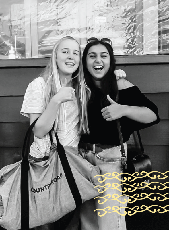 Photo of Sarah & Kushali standing together with thumbs up