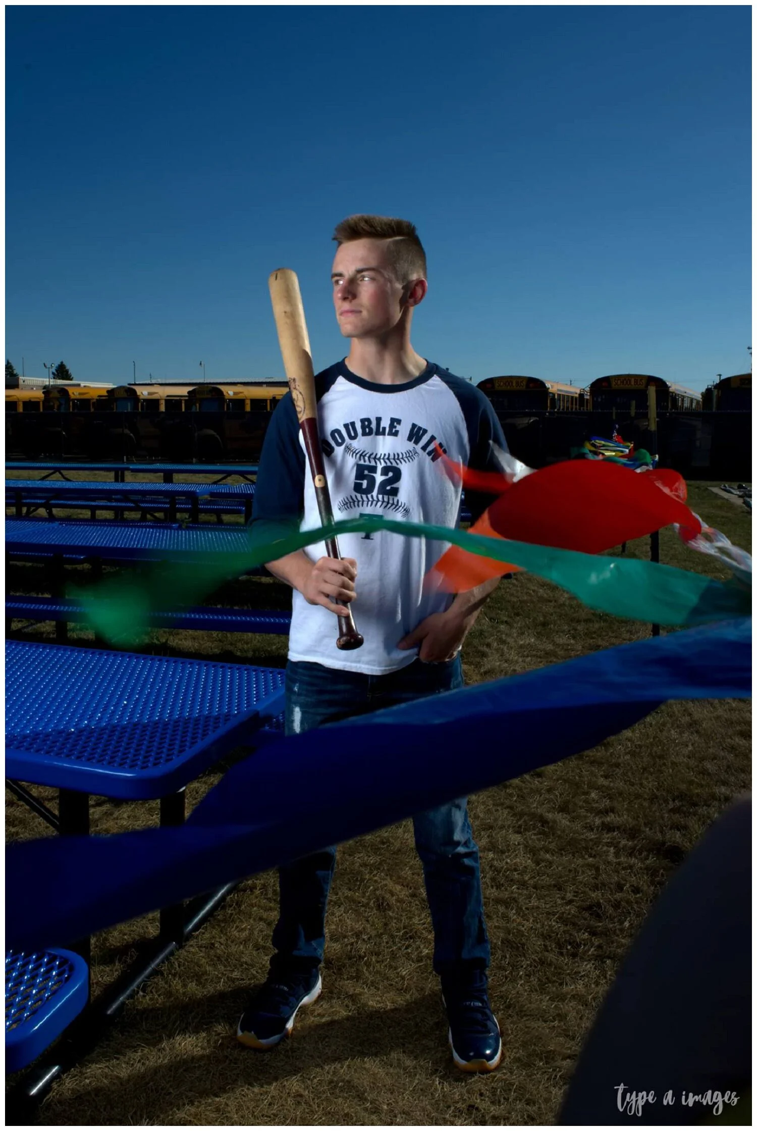 Every Senior Portrait season, there’s typically a location I gravitate towards in the midst of a shoot that gets an odd look from the senior….or their parents. Like…..um…..picnic tables? Old flags?   But what I saw here were bright primary colors an…