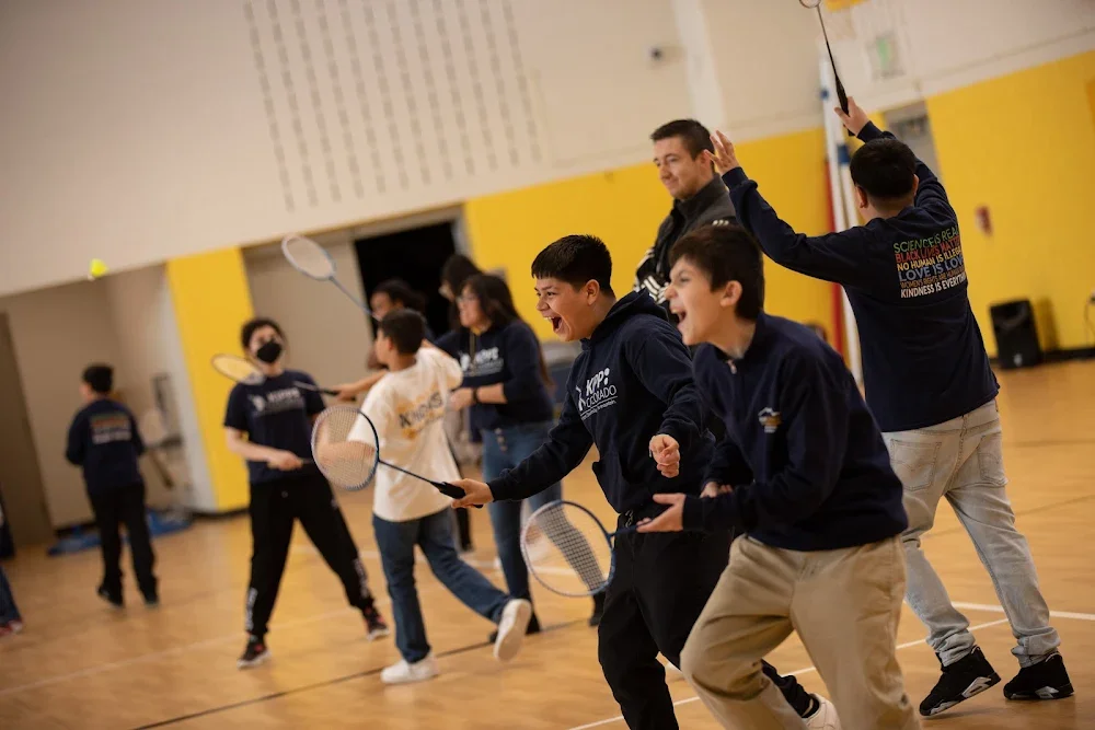 kids playing badminton in a school gym having fun from a school event shoot