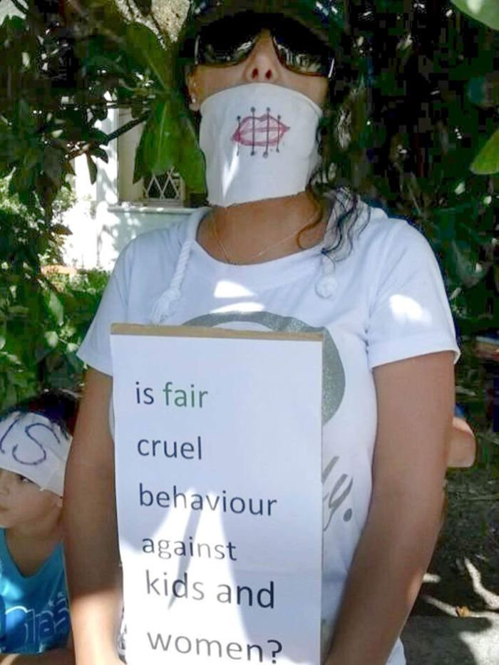 A protester on Nauru holds up a placard complaining about the treatment of women and children asylum seekers. Refugee Rights Action Network: Victoria Martin-Iverson Source: ABC. 