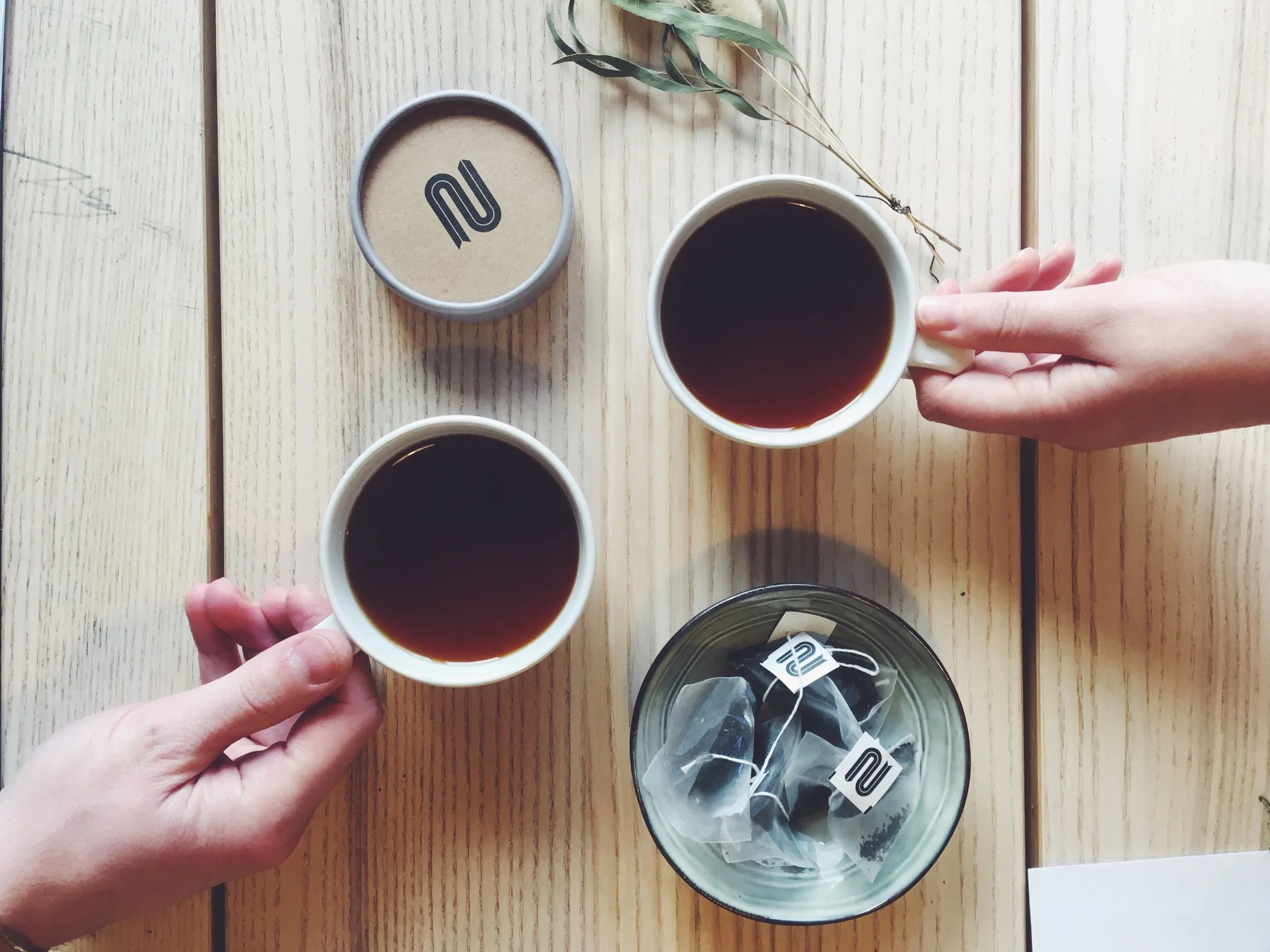 Two people drinking NEMI Tea in a hotel