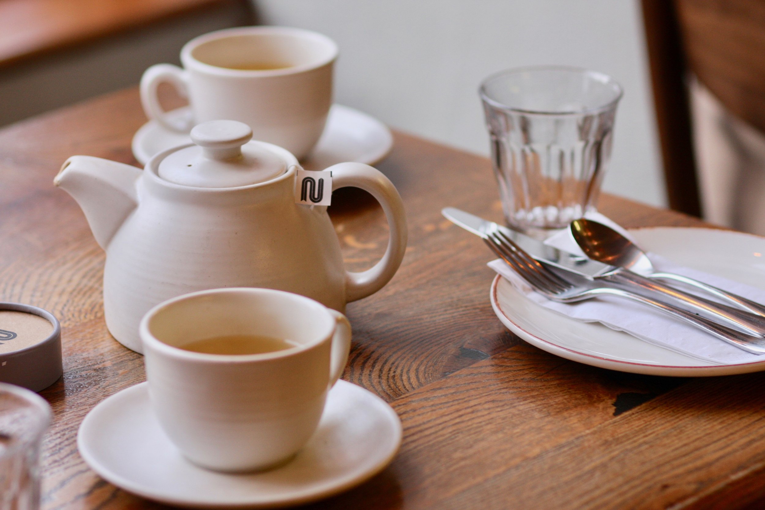 A pot of tea on a cafe table
