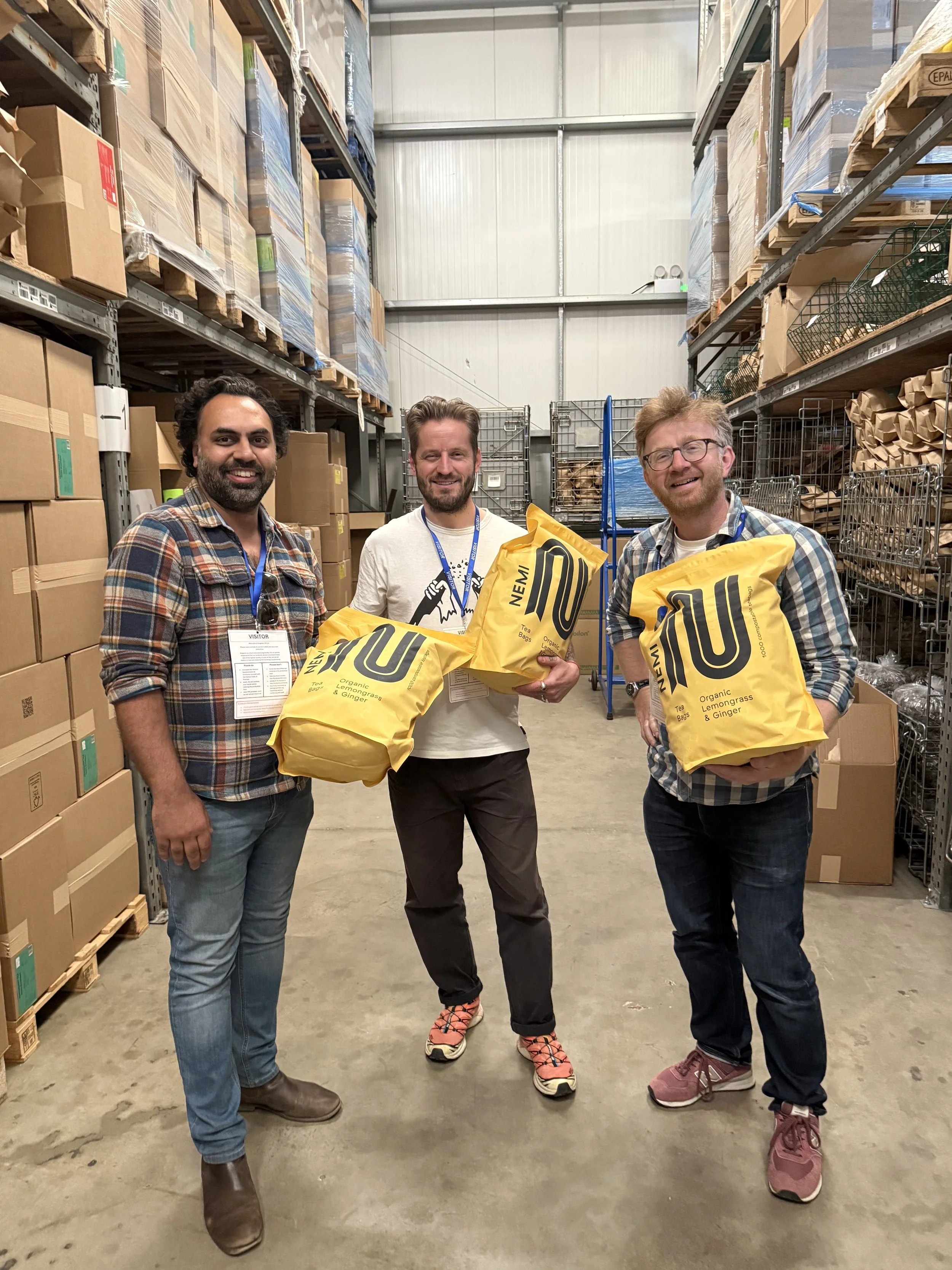 Pranav from NEMI alongside some tea distributors
