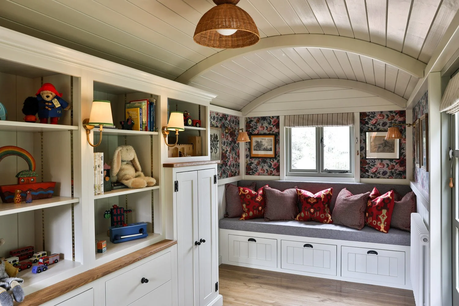 The interior of a shepherds hut with a bookcase for a childrens playroom