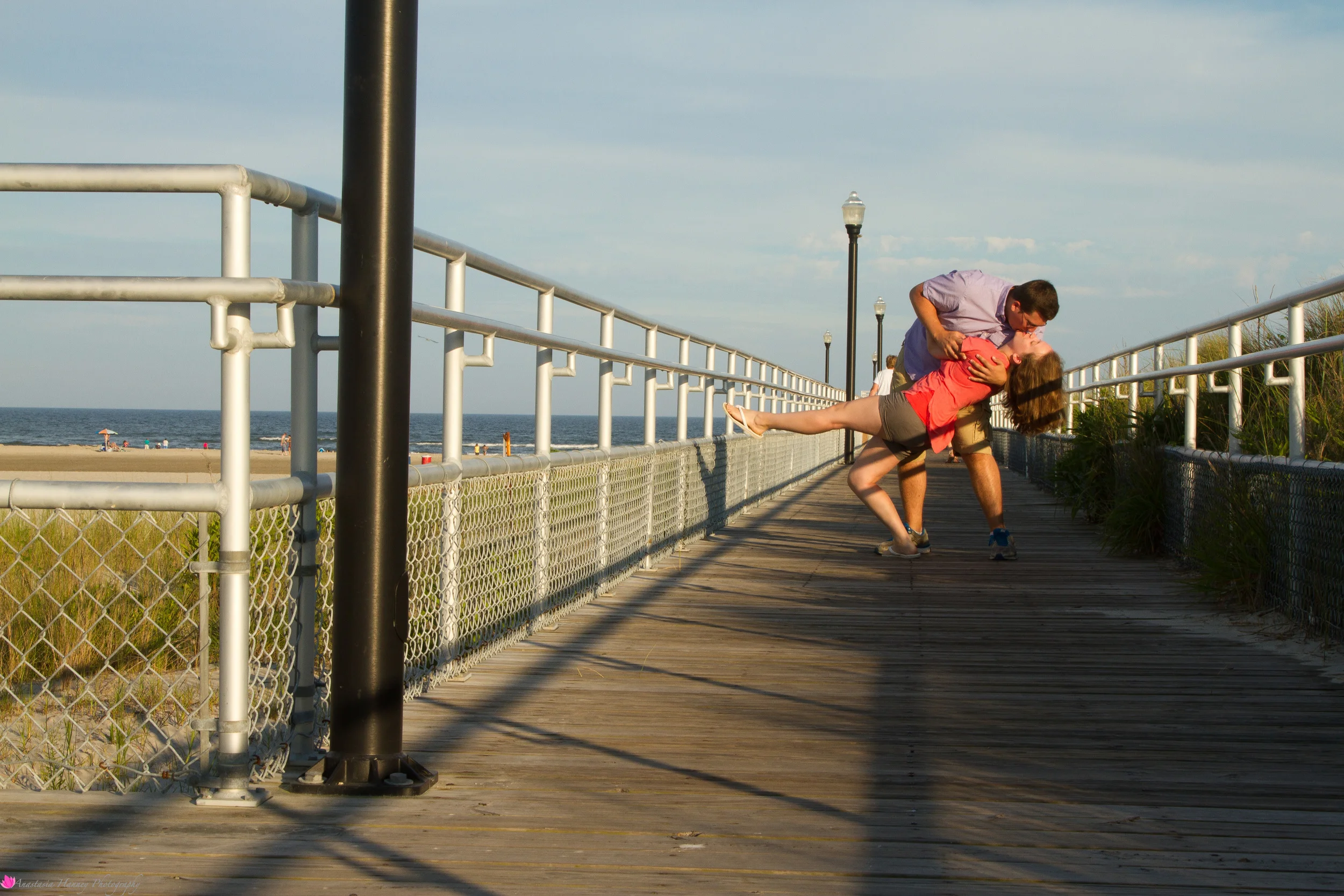 Engagement Photography Session of Couple on Boardwalk by beach in Wildwood New Jersey Shore by Anastasia Hanney Photography