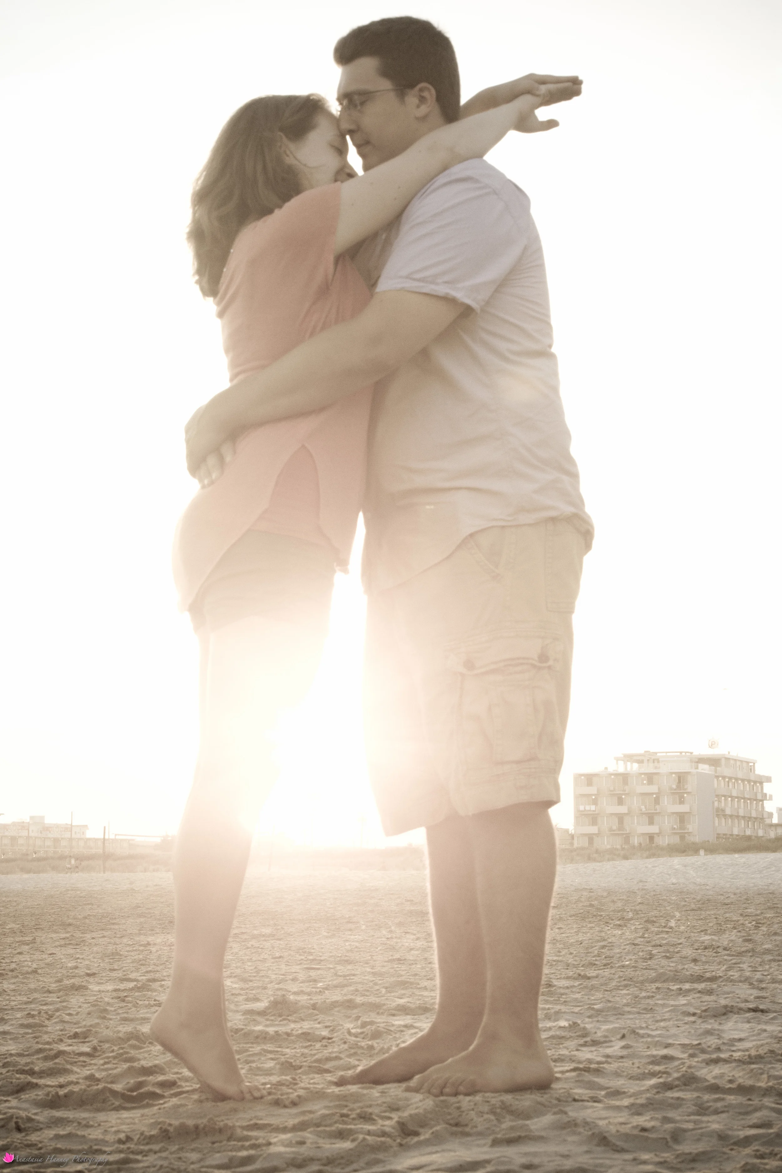 Engagement Photography Session of Couple on beach hugging in Wildwood New Jersey Shore by Anastasia Hanney Photography