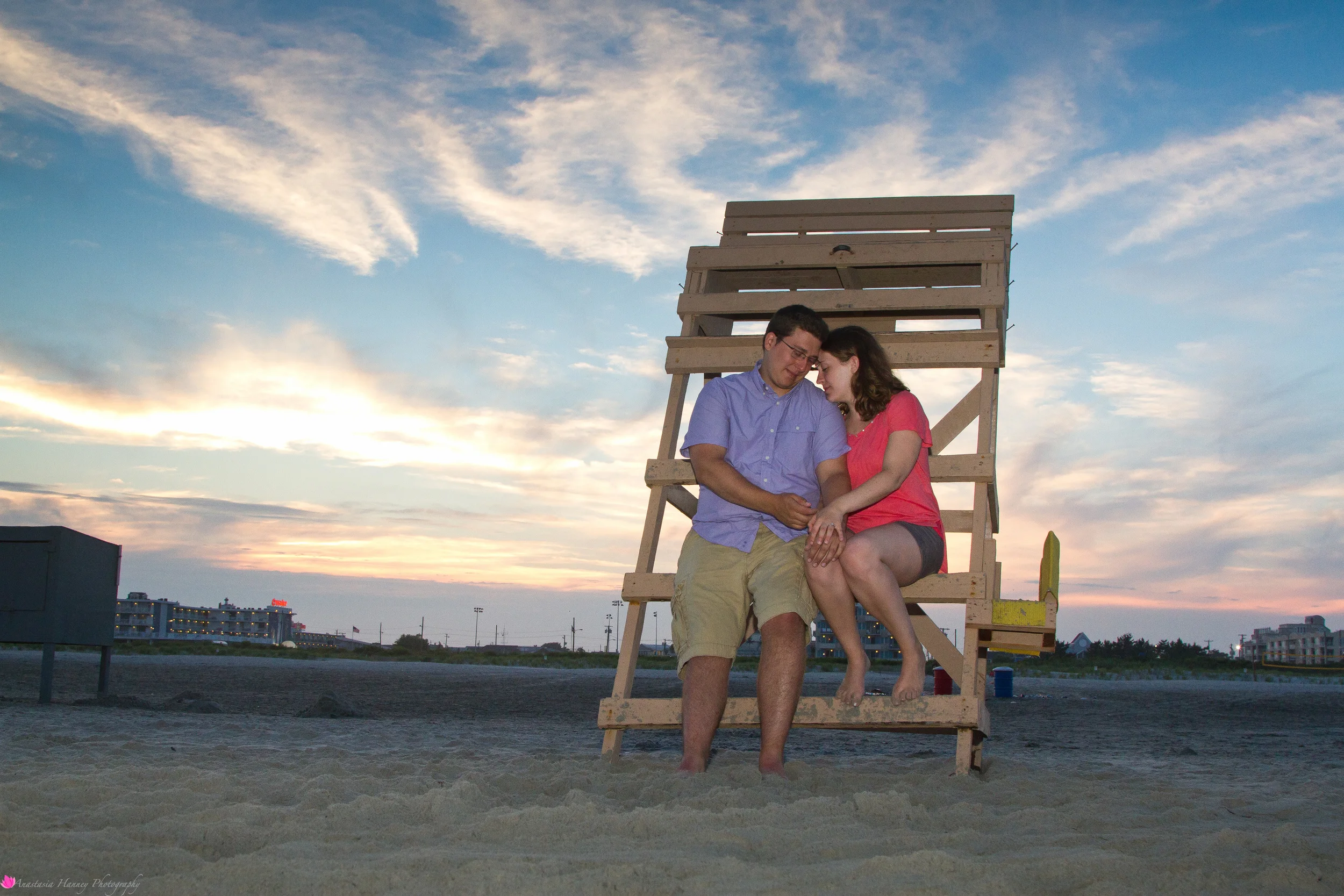 Engagement Photography Session of Couple on beach on lifeguard stand in Wildwood New Jersey Shore by Anastasia Hanney Photography