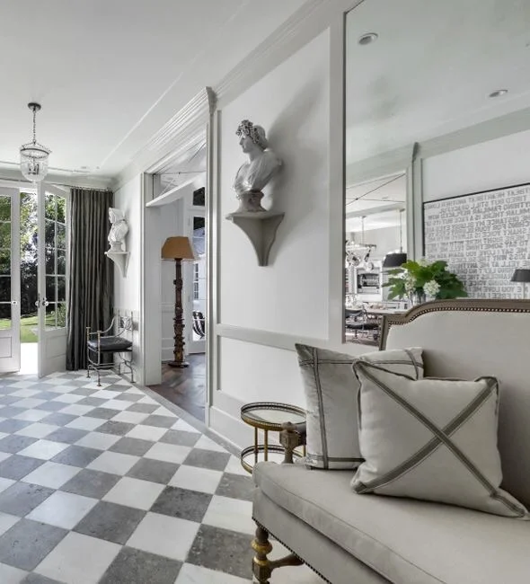Recycled marble flooring by Exquisite Surface and ceiling lanterns from Brighton Collection were chosen for this wide gateway smartly connecting the public spaces to accommodate entertaining.