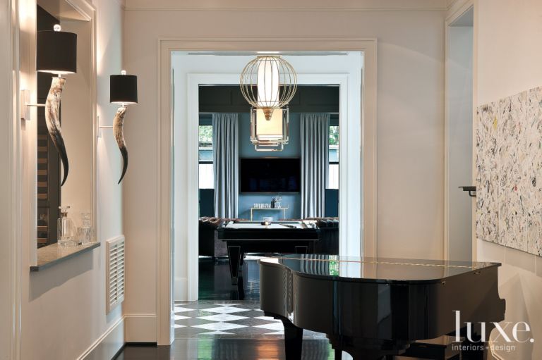 Billiard room includes tufted leather chairs from Nest & Cot and a pony hair rug from Custom Flooring.