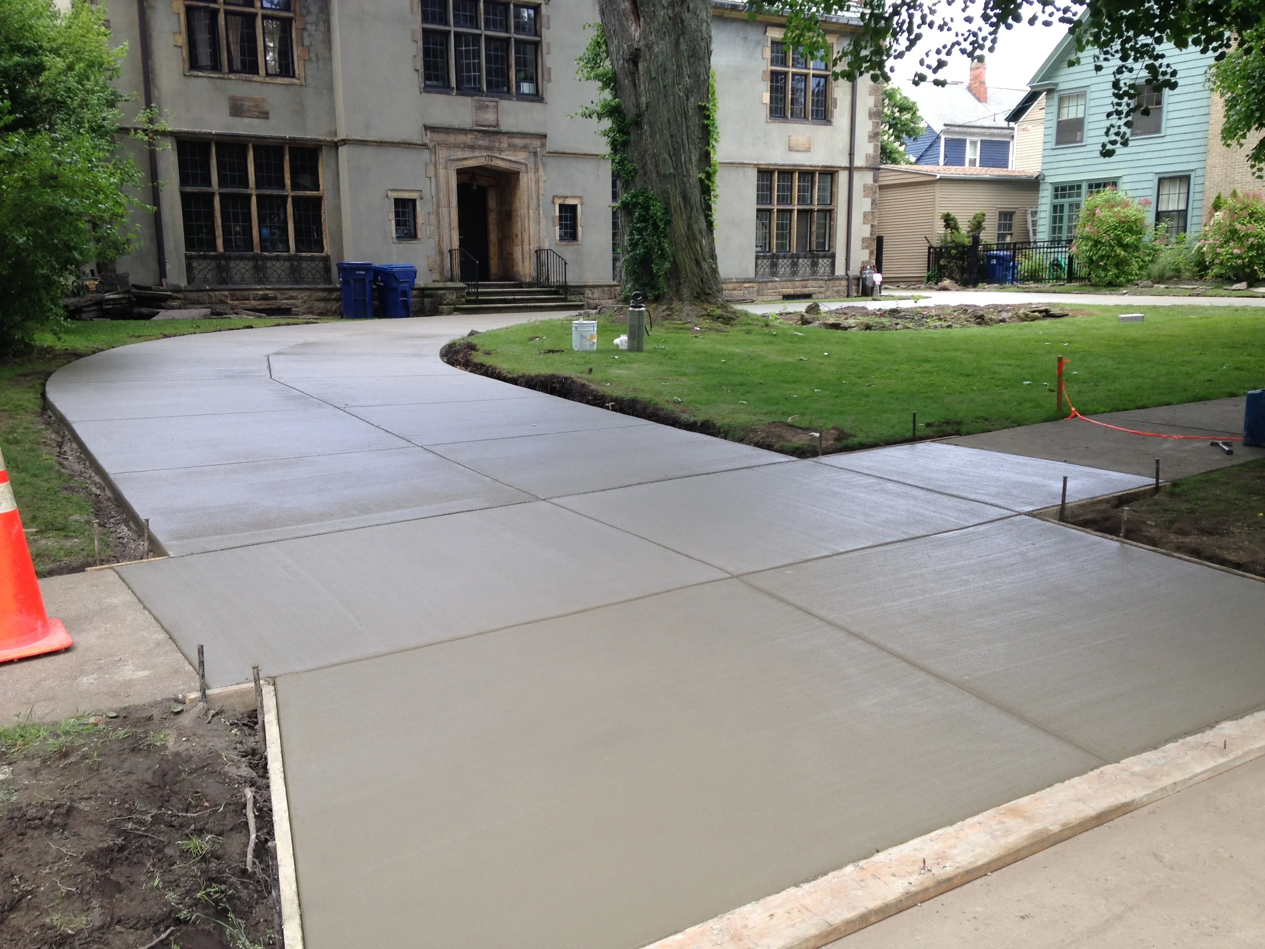 Setting concrete driveway that wraps around the front of a large building.