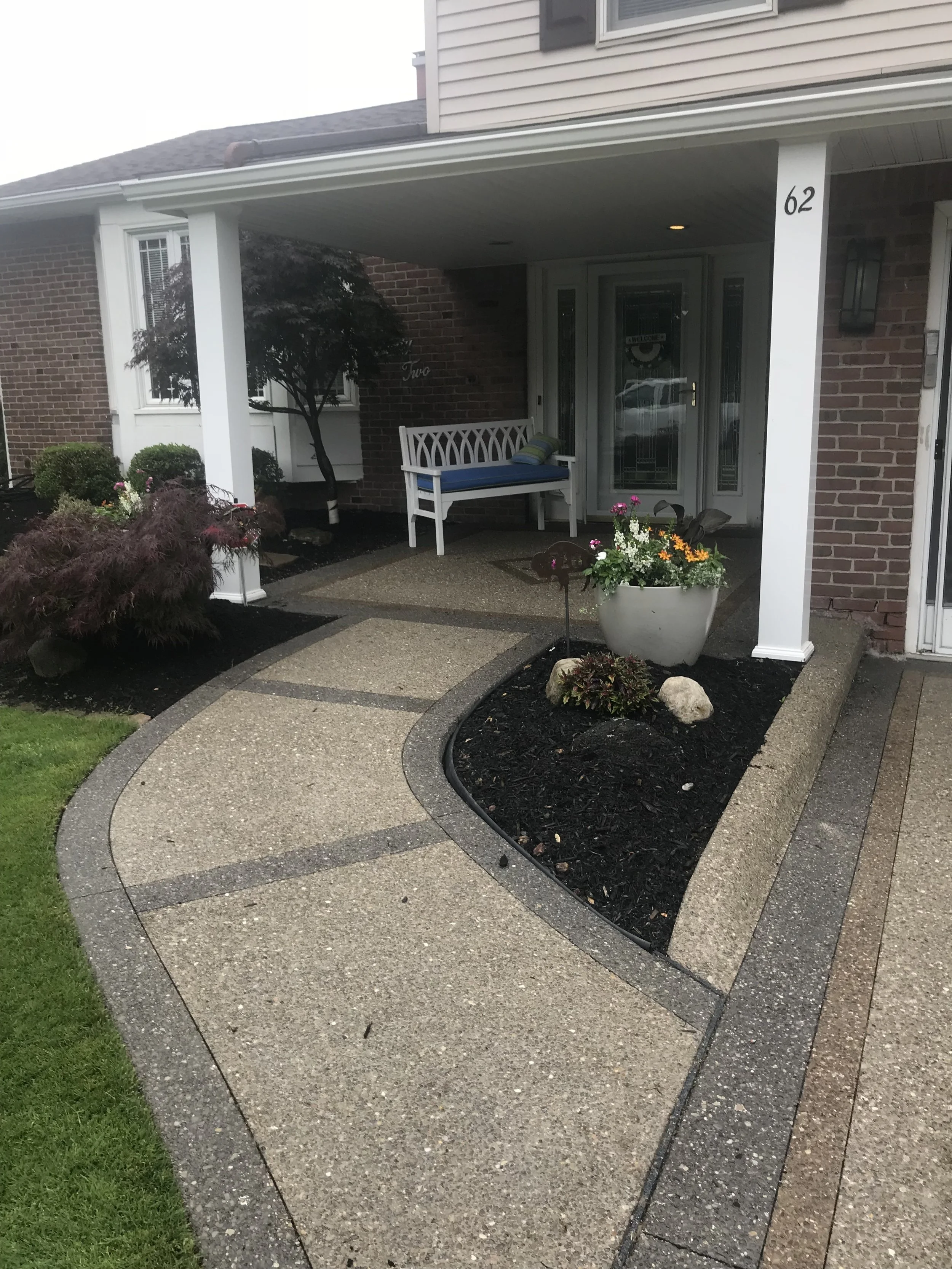 B&amp;W Custom Concrete Pathways to Porch . A short curved concrete pathway from the driveway, between two gardens, up to a concrete front patio.