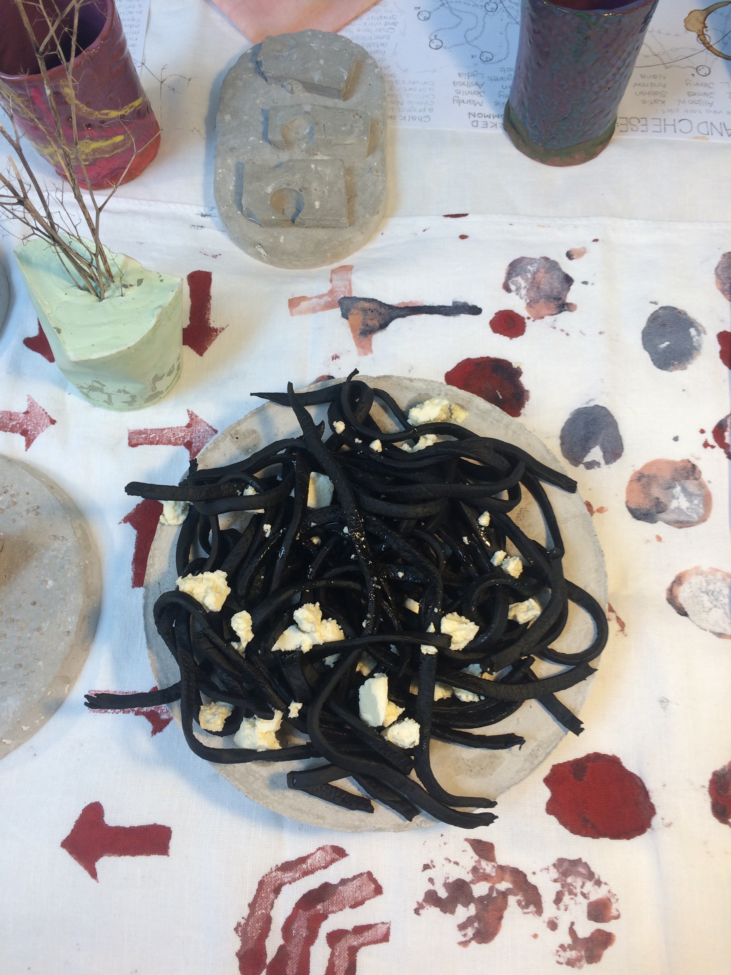  This is a detail of the table display for The Gathering showing slab-cups and concrete cast food platters made in workshops with Lydia Brockless, vegetable block-printed table runner and tea towels made in workshops with Charlene Sandy using natural