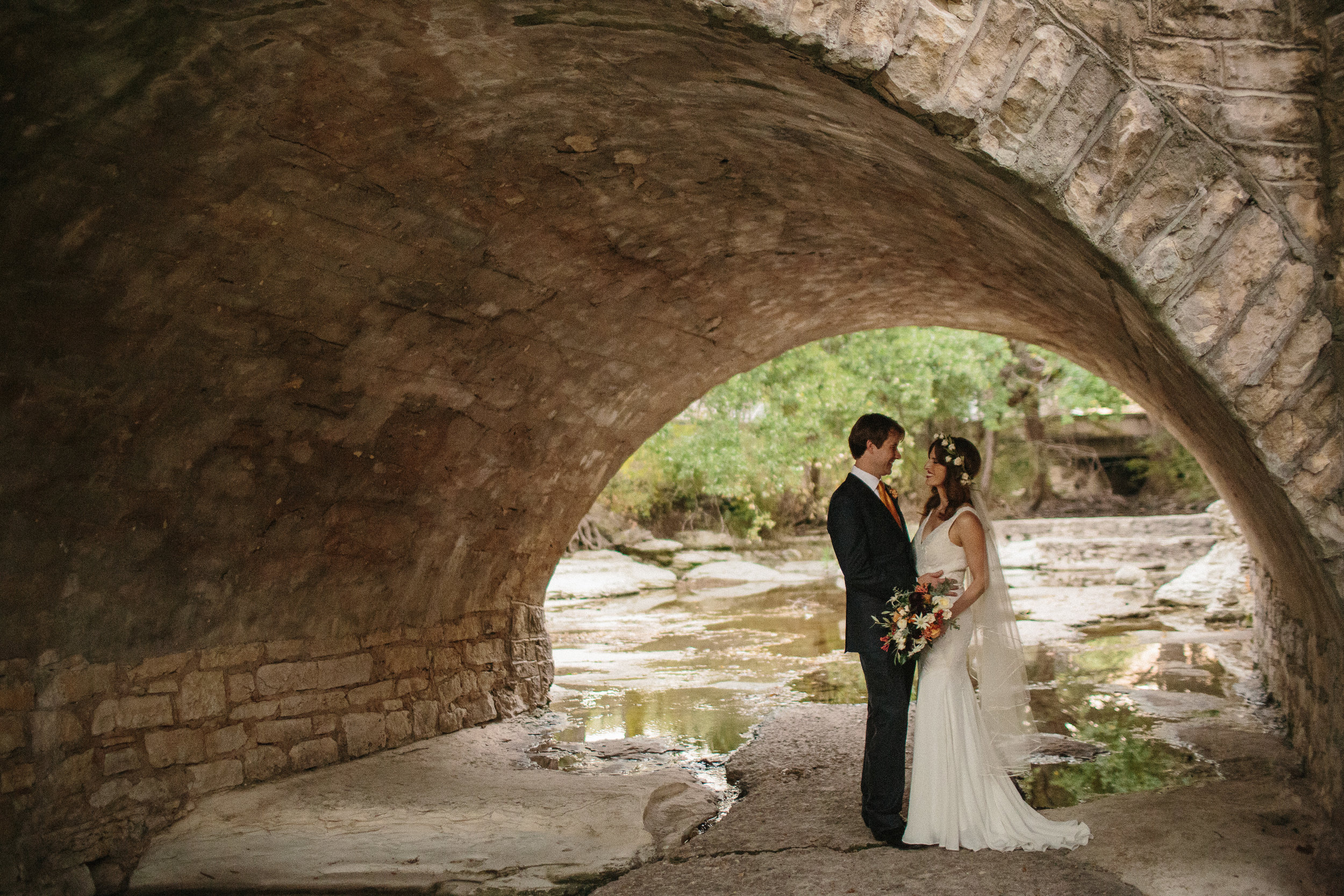  bride and groom under bridge by waller creek 