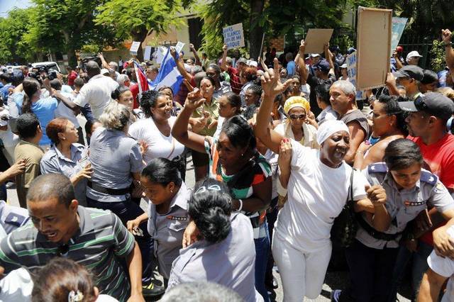 Cuban police detain members of Ladies in White, a dissident group of wives and mothers of political prisoners calling for their release. Desmond Boylan AP