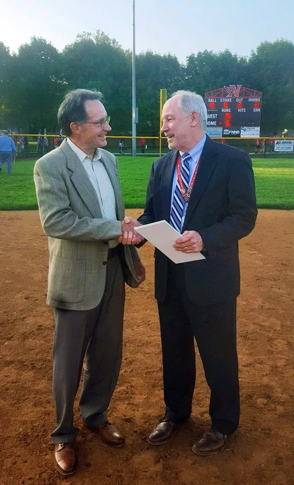 May 22, 2018 Bob Callaghan, superintendent of the Newton Community School District and Paul Koester, president of Koester Construction shake hands at the Newton Softball Field Dedication Monday night. While this marks the first professional project the pair have completed, Bob and Paul have worked together in the past - the distant past! 45 years ago, Bob and Paul were high school classmates. The two reunited at a high school once again last night to celebrate the completion of the Newton Softball Complex and dedicate the field! This Koester Construction project included the softball field, a storage shed, two dugouts, and bleachers for Newton Cardinal fans!