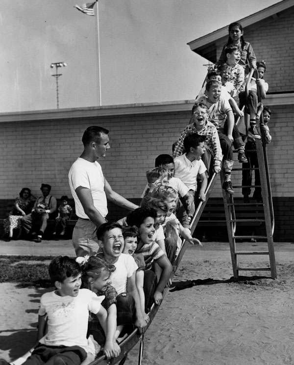  1951:&nbsp; Normandie Playground SLIDE Jerry Jakway, recreation director at Normandie Playground, supervises a slideful of vacationing youngsters in the first full week of 1951 summer vacation. Hundreds of thousands of children are participating in 