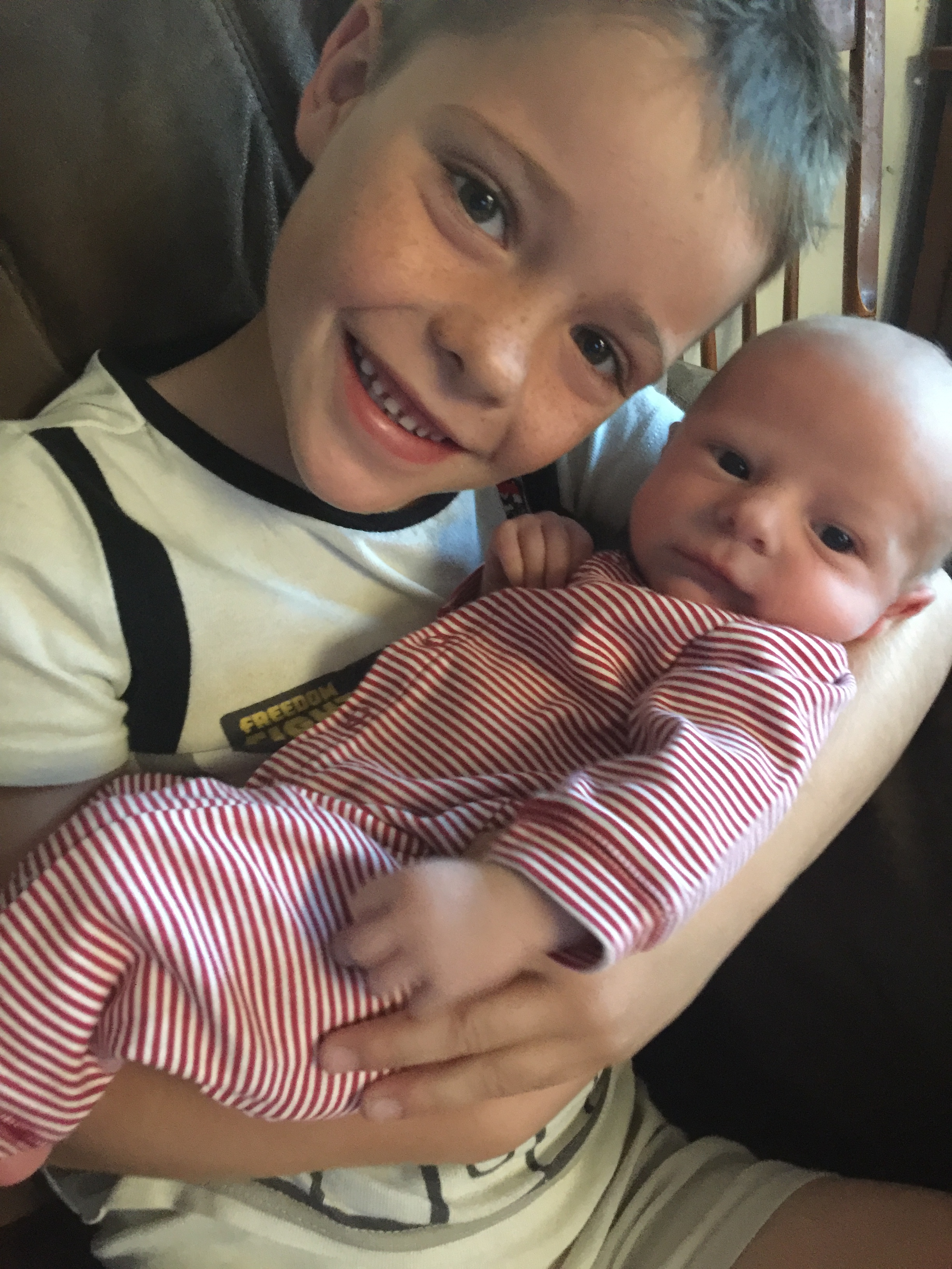 Quinn is a big helper with quade and can't get enough of his little brother!