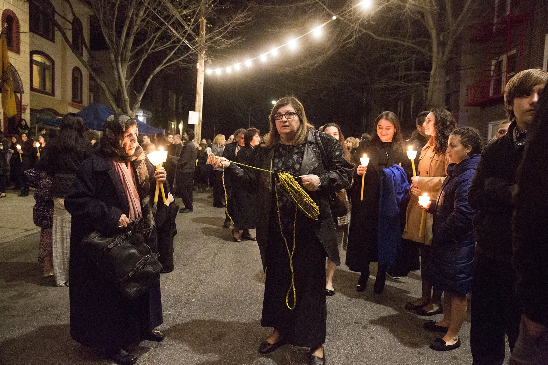 April 14, 2017. A woman holds a rope that’s used to create a boundary between the marching congregation and the decorated bier.