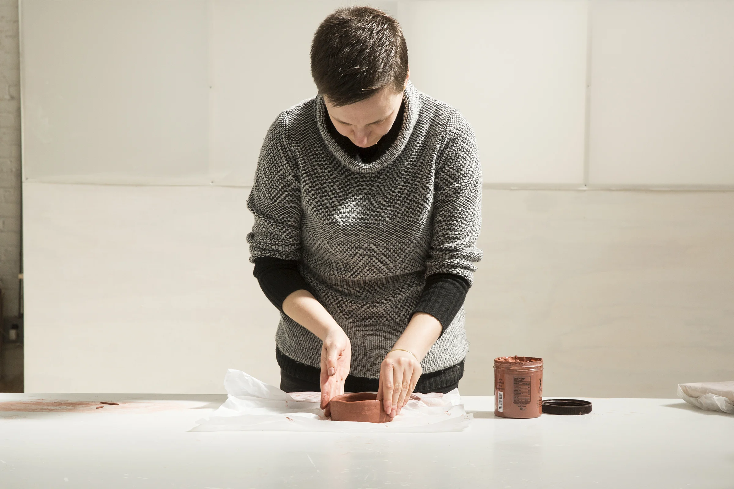  Building up the coil on the mug base. She smooths the inside and outside as she goes to create a clean surface.  