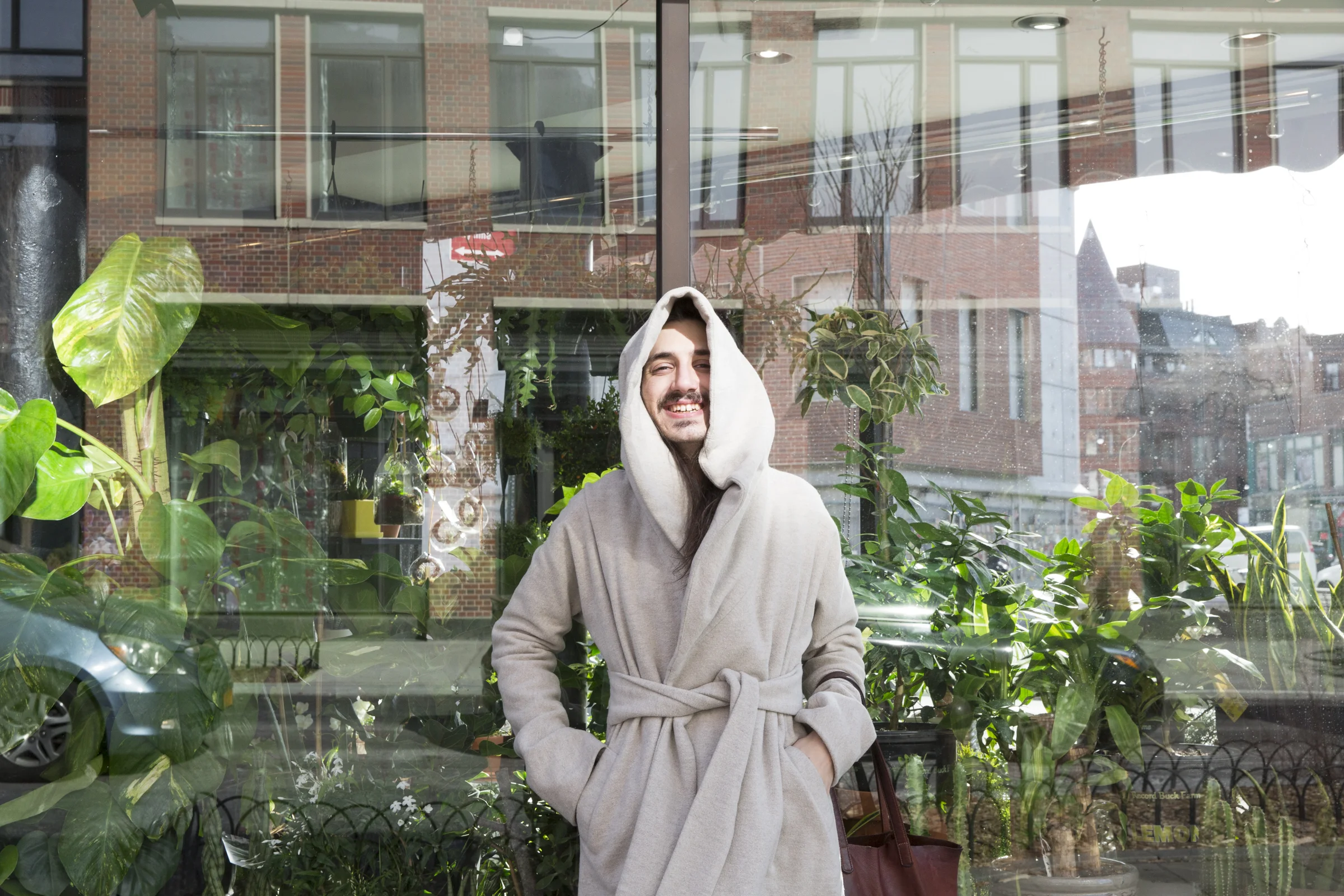  Aaron stands in front of the window of The West Village Florist. Having a deep appreciation for the natural world and biology, they connect with plants and wildlife wherever they can find it in New York City.  