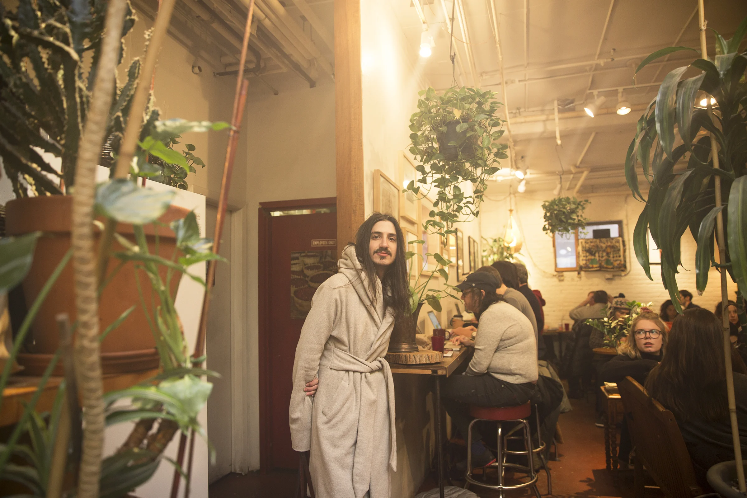  Aaron at Grounded Coffee House on Jane Street. With the space full of plants and floral arrangements, they find this space peaceful and often come here to work.  