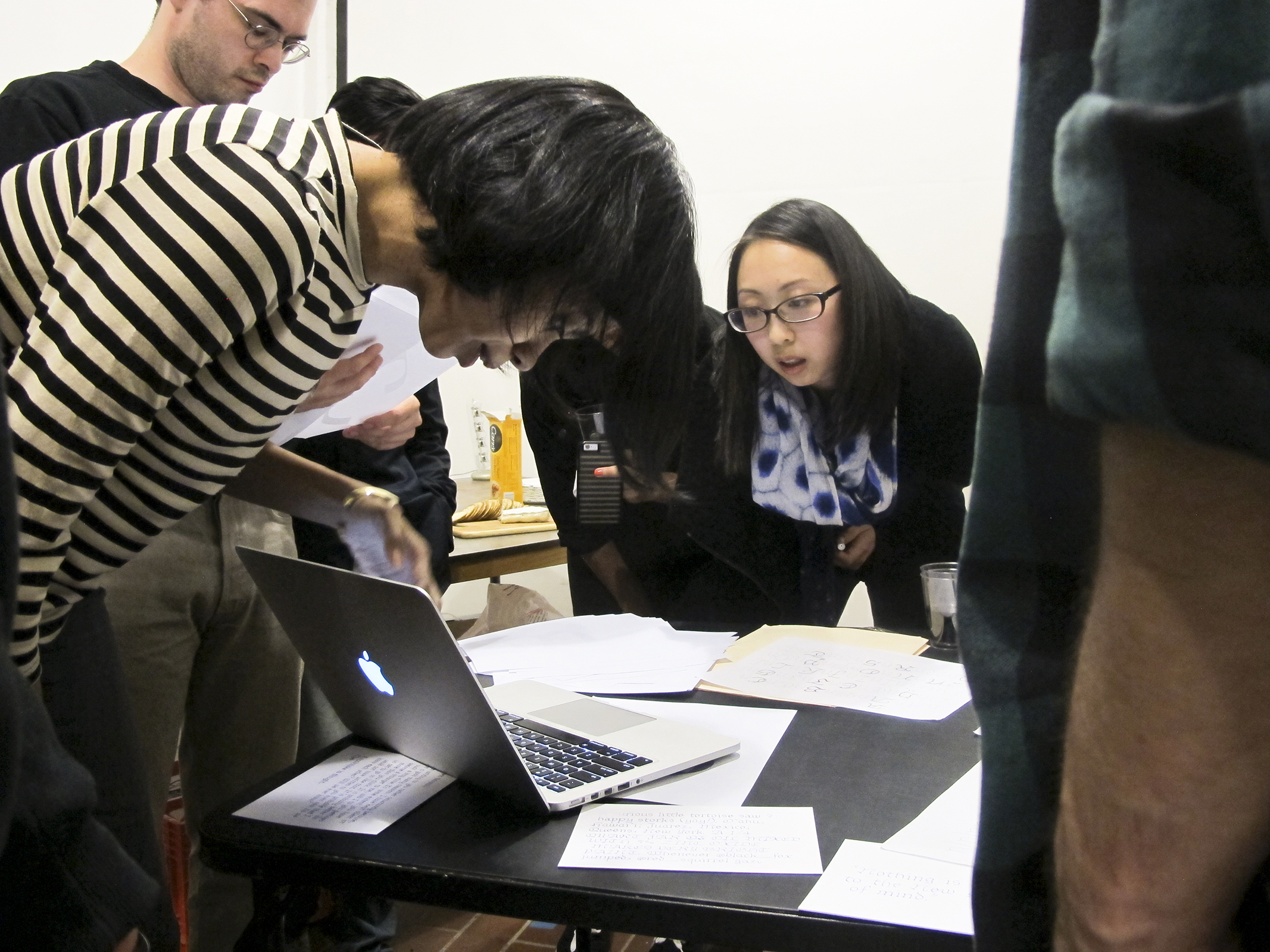 Shayma (left) leans over a laptop to view details of a project up for critique at The Bakery. April, 2016