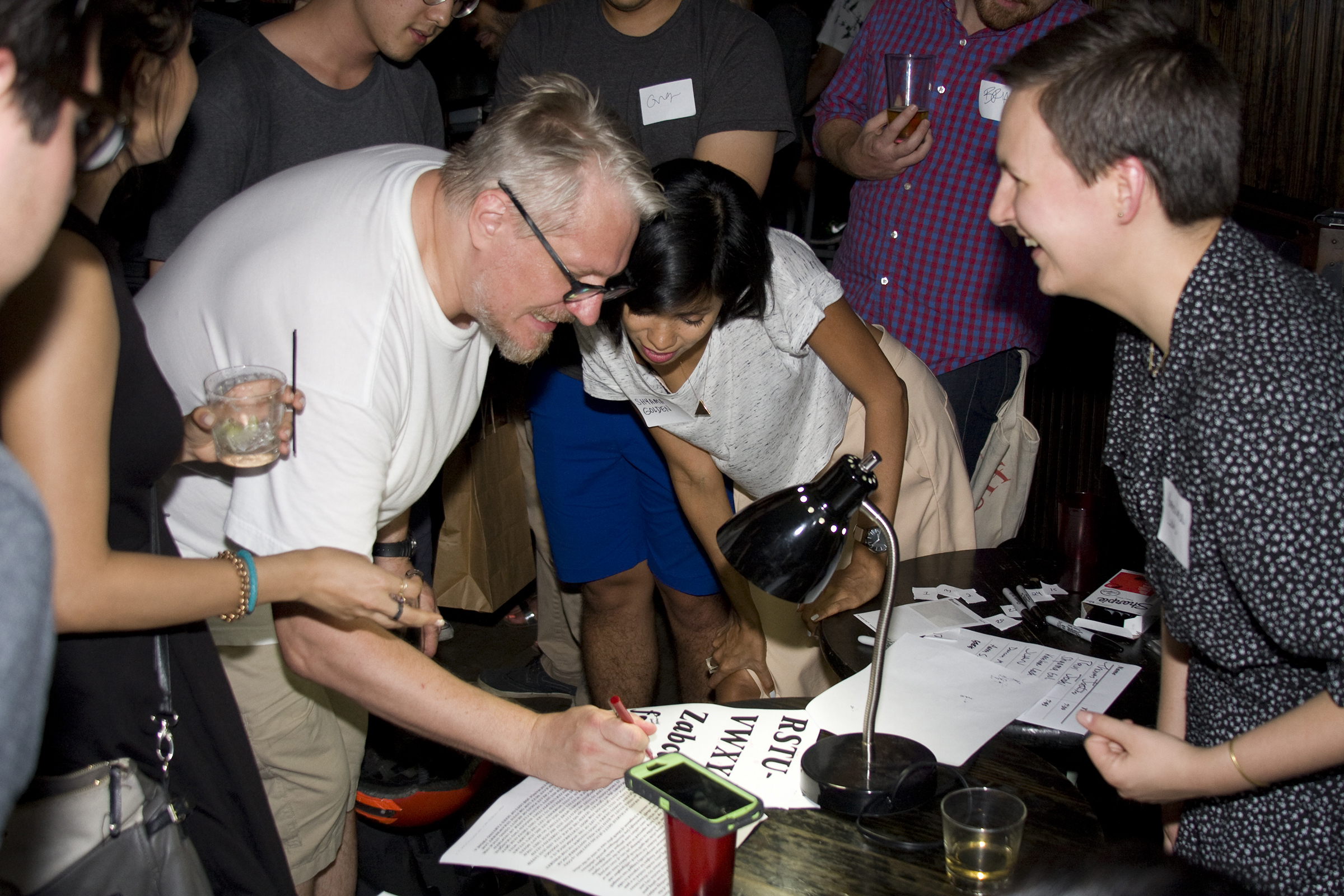 Hannes (left) writes comments on Shayma’s (center) typeface at the second TypeThursday meet up at Trophy Bar in Brooklyn. September, 2015