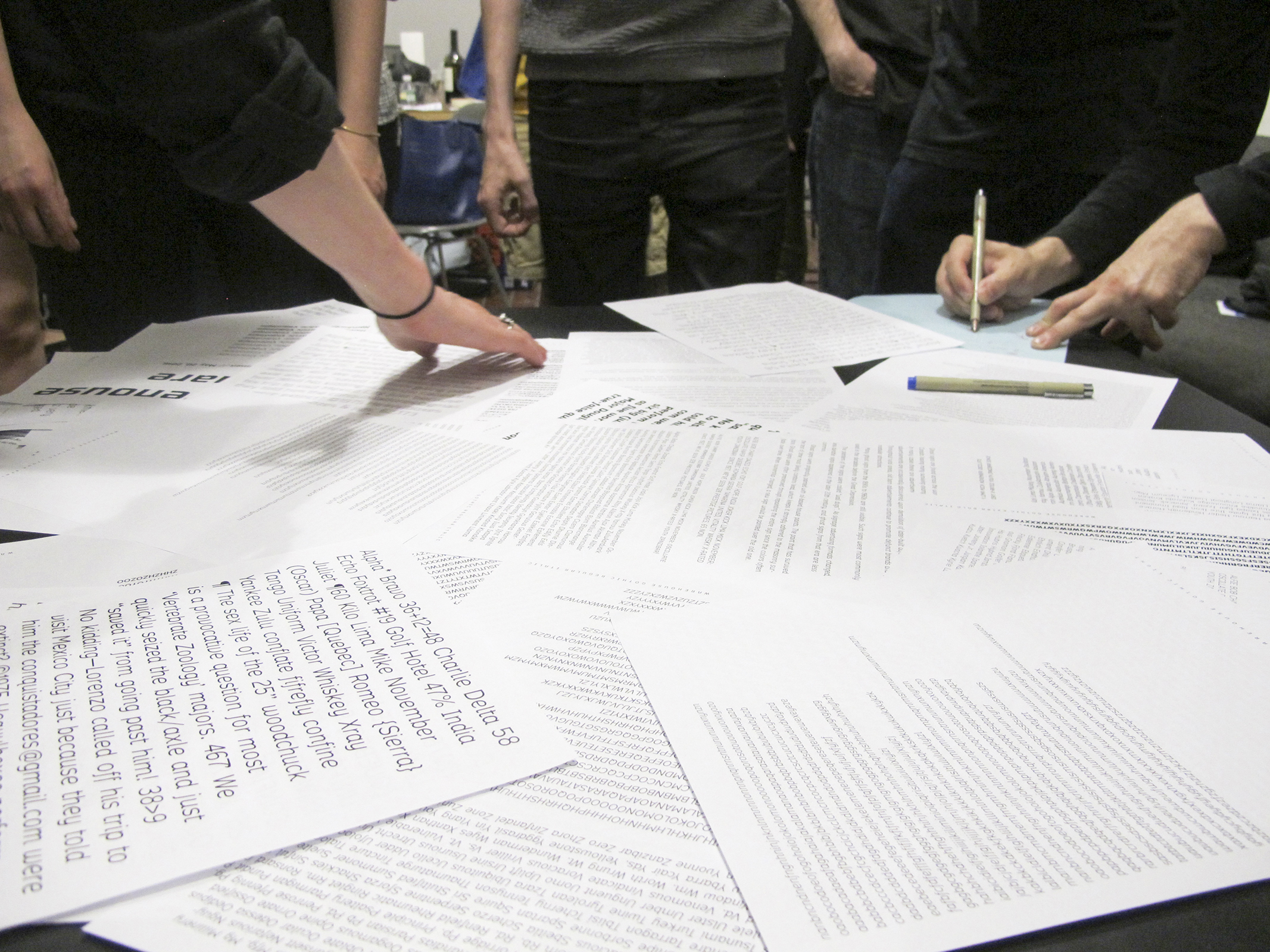 The group reviews print outs of layouts in June, 2016