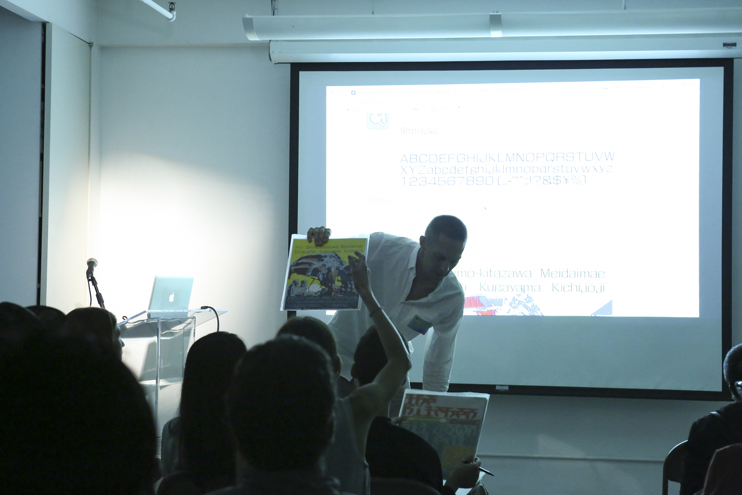Anselm passing out screen print posters he’s made. Once TypeThursday was hosted at Type Director’s Club, a projector became the dominant form of showing work and hard copies were less frequently presented.