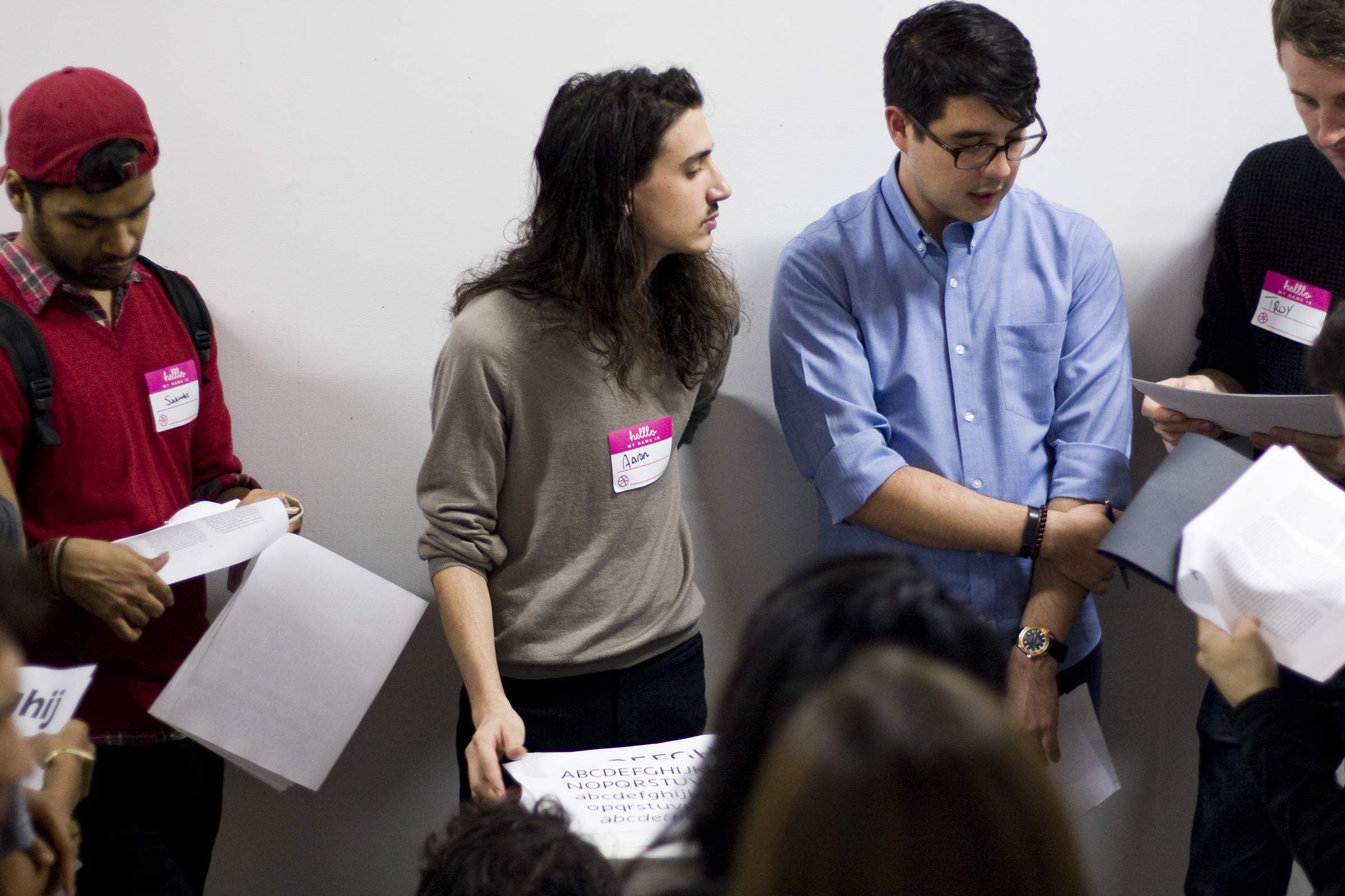 Aaron (center) listening to feedback on their project while the attendees look at their printed samples. November, 2015