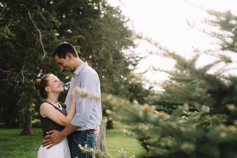 Erin and Scott hug near a tree