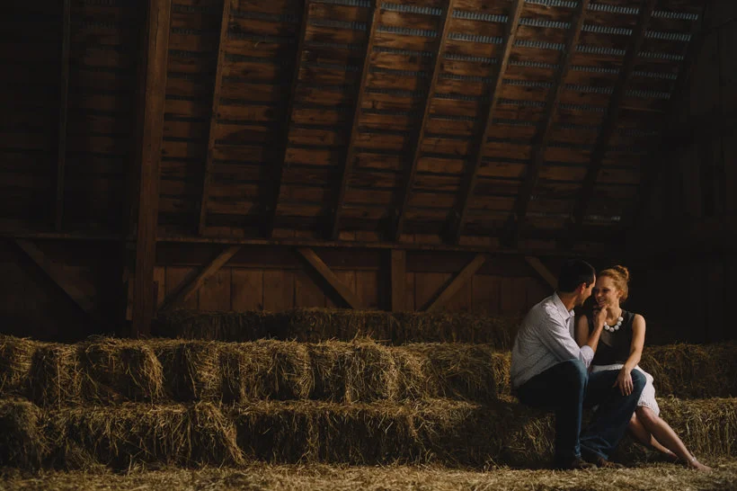 Erin and Scott huddle in the attic of a rustic barn