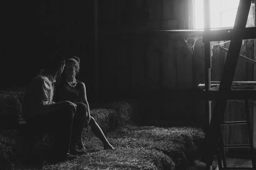 Erin smiles at Scott in the attic of a rustic barn