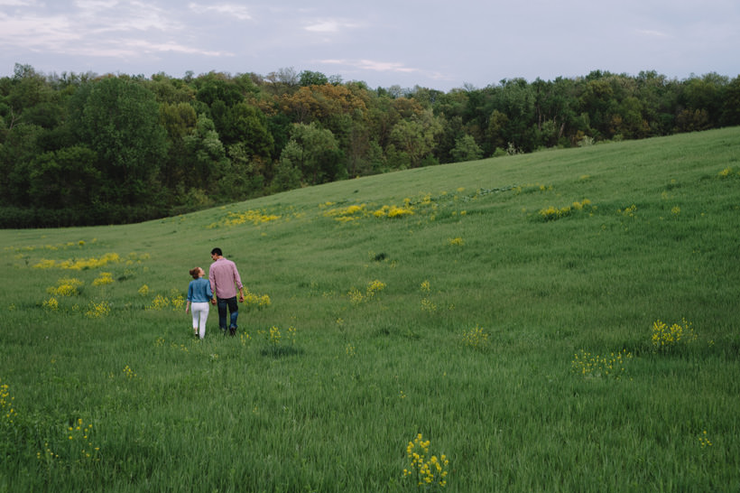 Erin and Scott stroll through a beautiful field