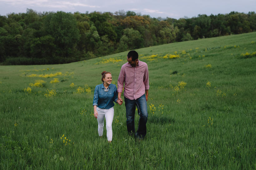 Erin and Scott stroll through a beautiful field