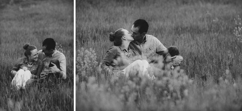 Erin and Scott huddled in a field with flowers