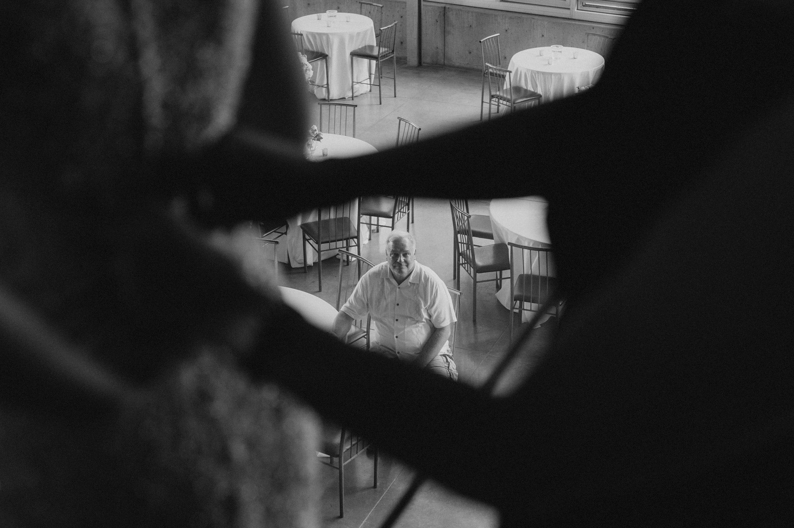 A stepfather watches as his daughter gets into her wedding dress | Iowa Wedding Photographer Brian Davis