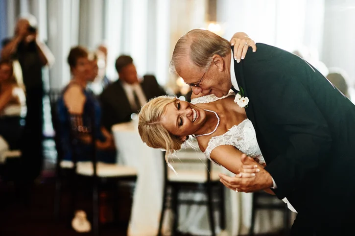Sarah enjoys a dip with her father during their wedding at the Temple for Performing Arts | Des Moines Iowa Wedding Photographer Brian Davis