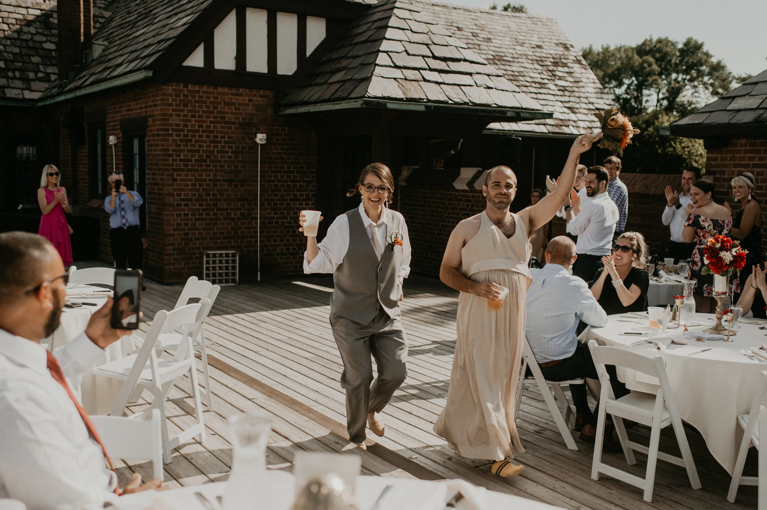 A bridesmaid and groomsman switch clothes | wedding photogrpaher