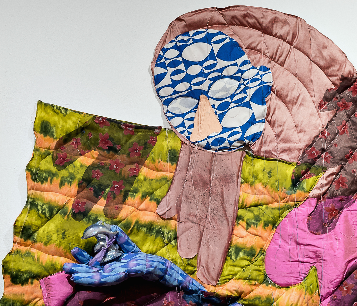 Catching Dolphins (detail), 2016, fabrics, batting, thread, stuffing, and dolphin figure, 65 × 54 × 4.5 inches.