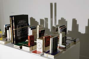 9 Foreshadowing things to come: Western Australia’s state of art: ANDREW PURVIS Mounir Fatmi, Save Manhattan 01 , 2003–04, books, strings, spotlight and table, 68.5 x 150 x 90cm; State Art Collection, Art Gallery of Western Australia, Perth, purchased 2013; © Mounir Fatmi, 2003-04