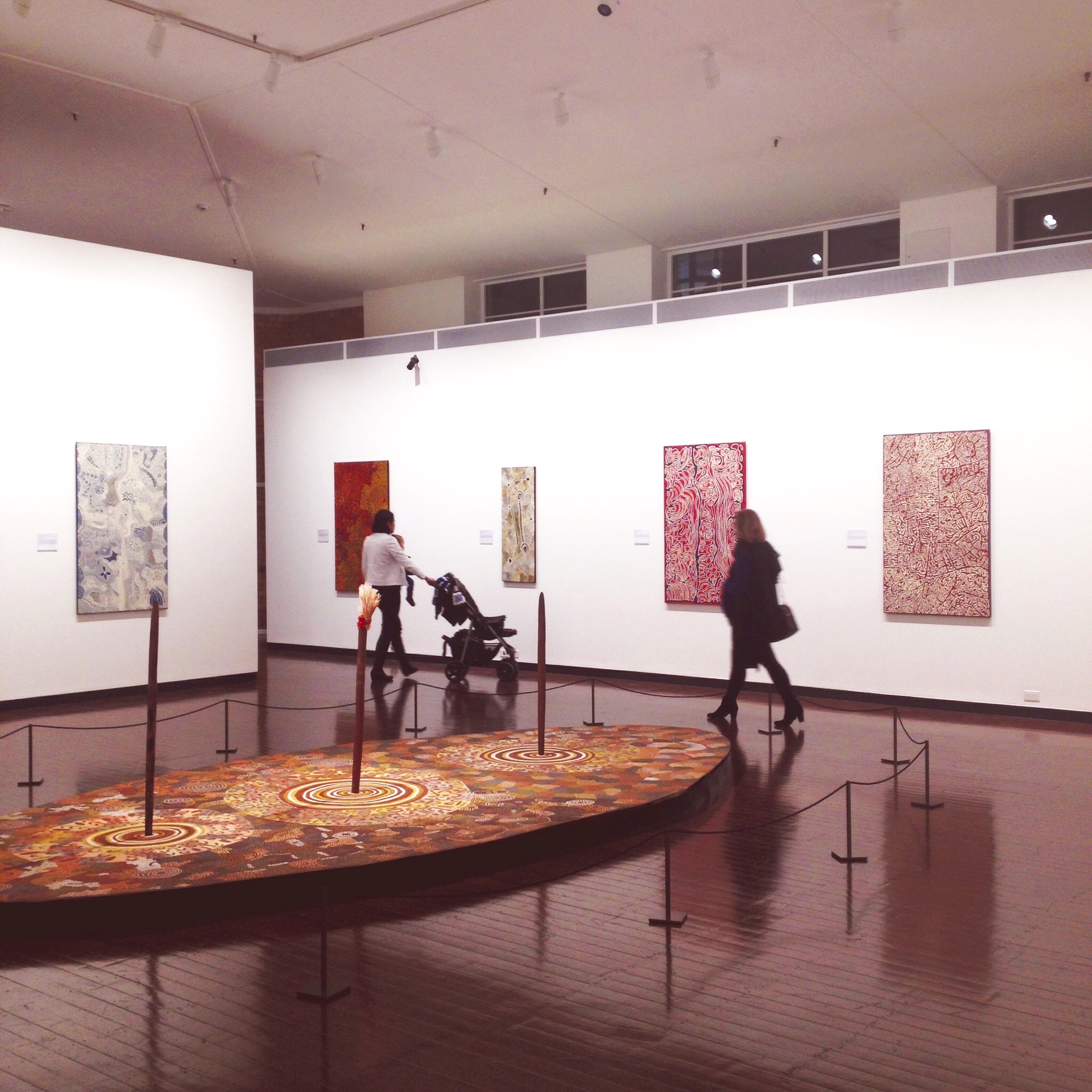 Visitors at the 'Streets of Papunya' exhibition showing at the Drill Hall Gallery, canberra
