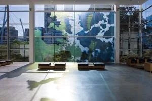 6 Critical Mass: My Country, I Still Call Australia Home, GoMA: RUBEN ALLAS Megan Cope, Fluid Terrain , 2012, vinyl on glass (art work produced from watercolour and synthetic polymer paint on military maps with digital text), site-specific commission for My Country, I Still Call Australia Home: Contemporary Art from Black Australia ; image courtesy the artist