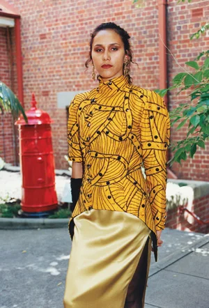 7 From practicality to spirituality: WA Indigenous fashion design: CHRISTIANE KELLER Ron Gidgup, Gown , yellow satin, silk jacket with beaded pattern; worn by Roseanne Gillespie, Kwobinyan Bokka fashion parade, Wes tern Australian Museum, 1993. Image courtesy Western Australian Museum