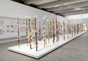 2 String bags and starry skies: Aboriginal fibre art at QAG: DANIEL THOMAS Banumbirr (Morning Star poles) installed in Floating Life , GOMA, Brisbane, 2009, bark fibre string, cotton, feathers, native beeswax, synthetic polymer paint, natural pigments on wood. From the Bandigan Morning Star and Queensland Art Gallery Collections