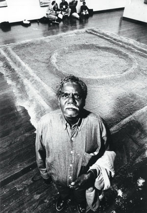 8 Jimmy Wululu (1936-2005) Bark painter from Arnhem Land: DJON MUNDINE Jimmy Wululu with Bongu (waterhole) sand sculpture at the ANU Drill Hall Gallery, Canberra, 1992. Photo courtesy of The Canberra Times